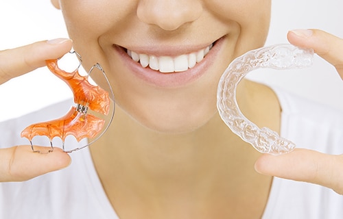 woman holding different types of retainers