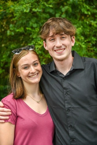 Maddux orthodontics male and female patients hugging after treatment
