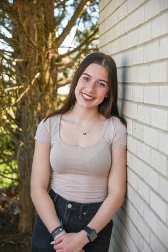 Teenager smiling post orthodontic treatment with straight teeth