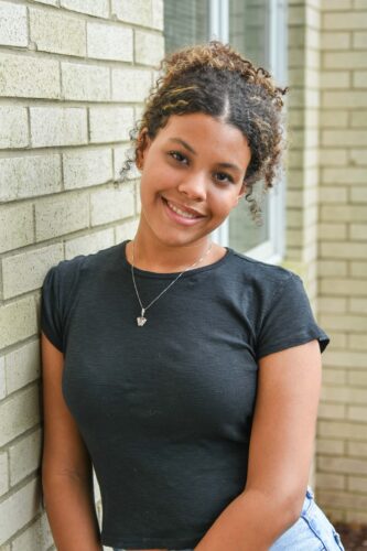 Smiling orthodontic patient after treatment with straight teeth