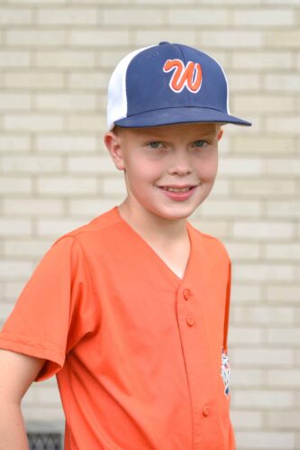 Orthodontic patient smiling outside of maddux orthodontics