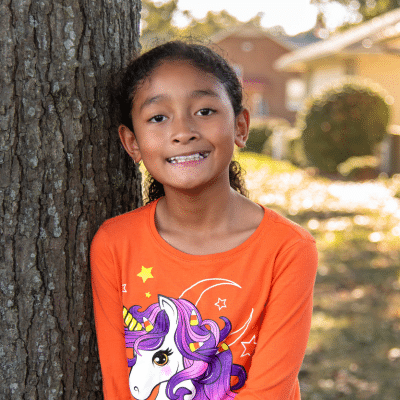 What to expect during your first orthodontic consultation 3 Little girl patient at maddux orthodontics smiling and posing for a photo, representing the first orthodontic consultation